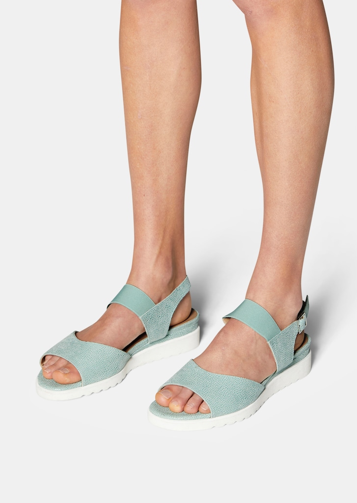 Flat sandal with heel strap