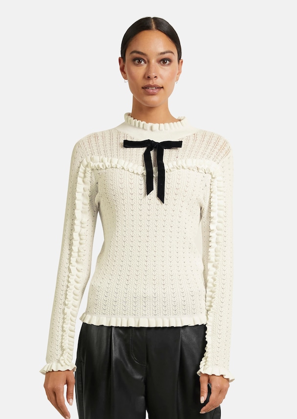 Ajour jumper with ruffles and decorative bow
