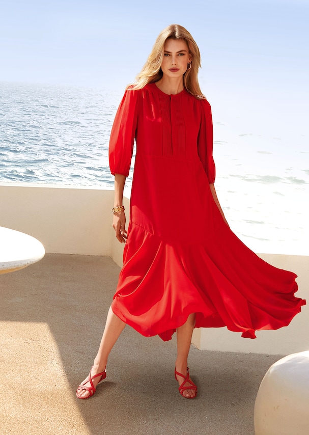 Dress with 3/4-length sleeves and sweeping hemline