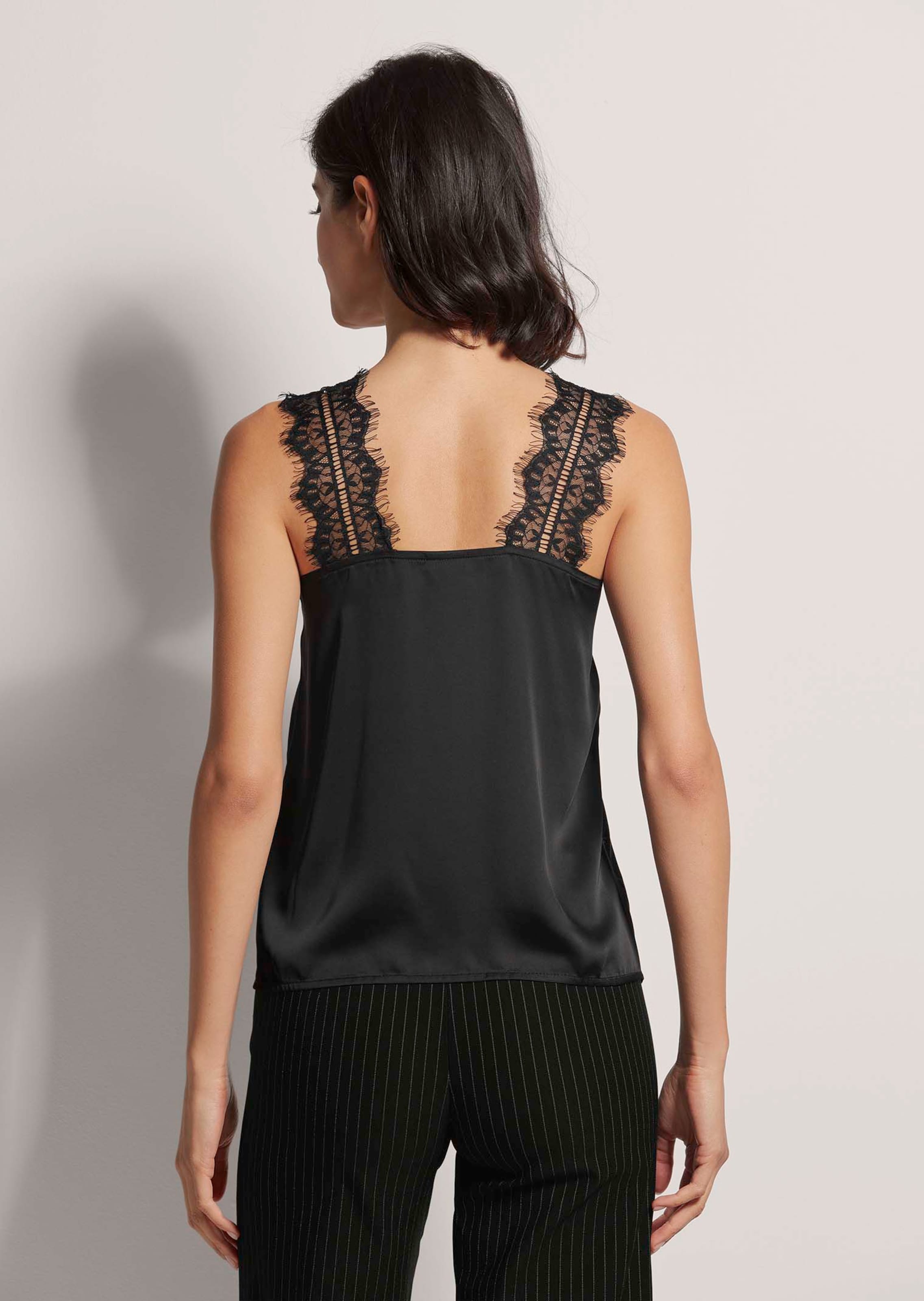 Satin top with lace in black | MADELEINE Fashion
