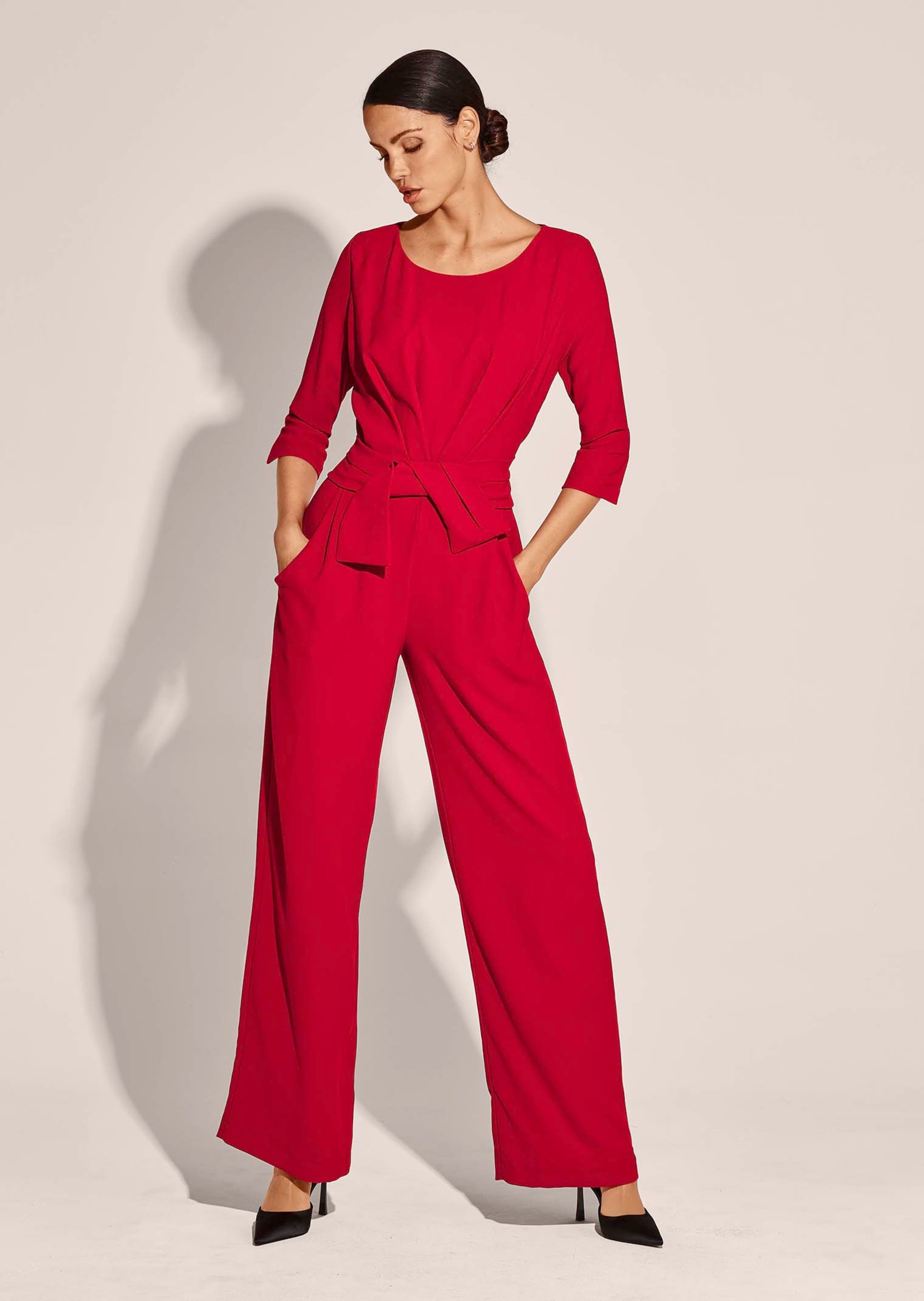 Belted wide leg jumpsuit in red MADELEINE Fashion