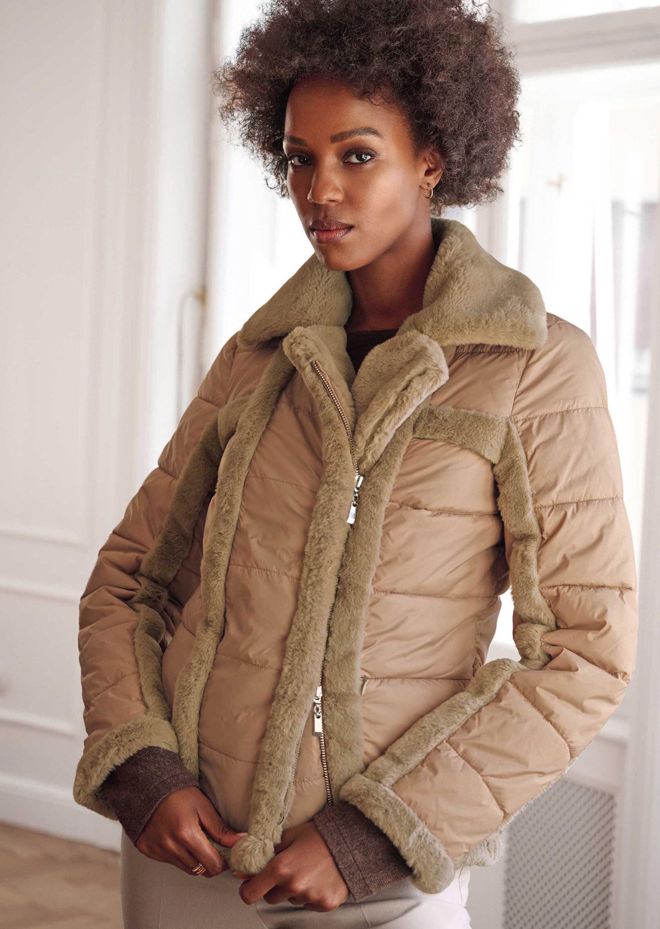 Biker-style quilted jacket with faux fur accents in dark