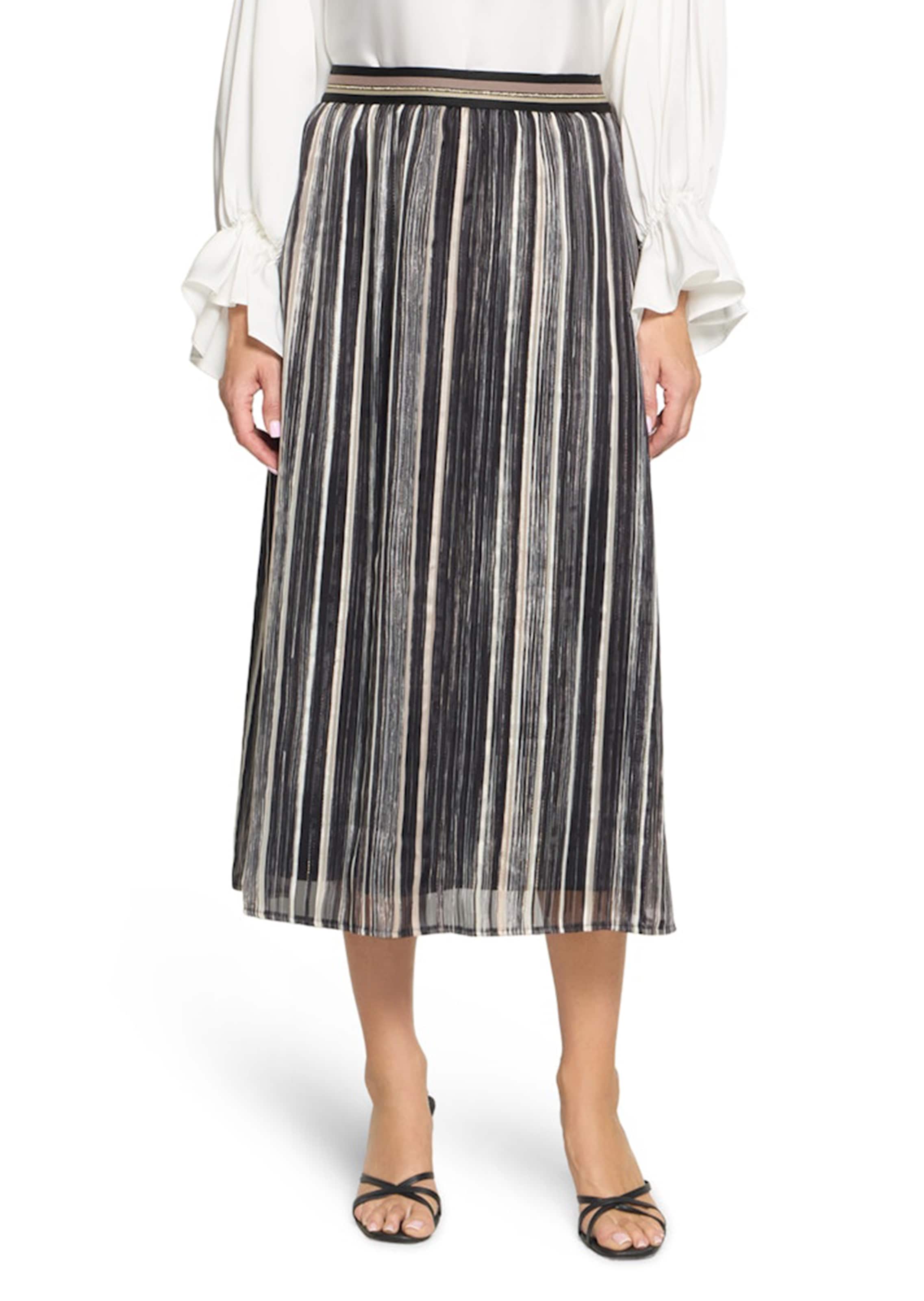 Ilmavasti laskeutuva hame, jossa kiiltäviä raitoja